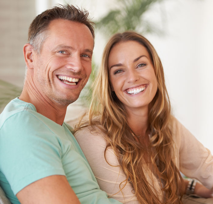 Man and women smiling show off their great smile
