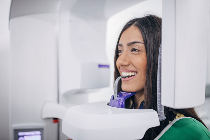 women being scanned by a 3D X-ray machine