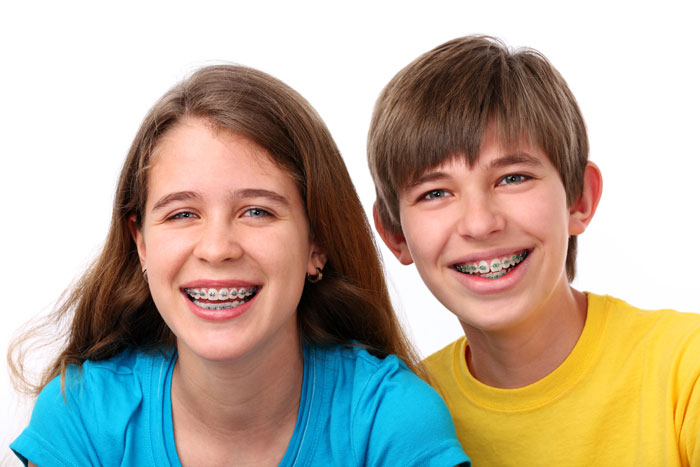 Boy and Girl with braces smiling