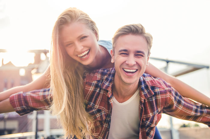 a Late teen couple smiling