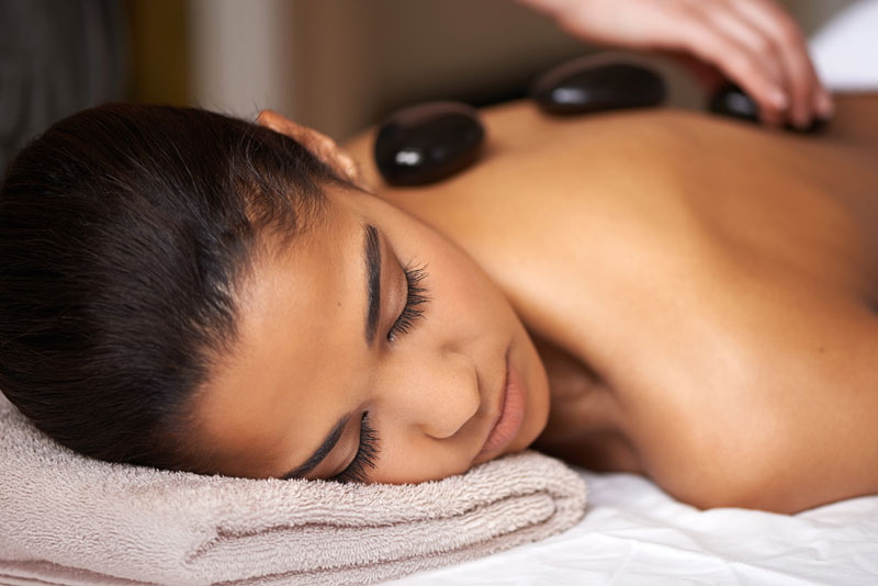 women enjoying a hot stone massage